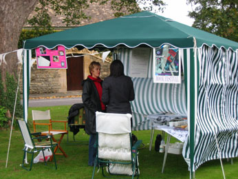 green gazeebo on village green with people discussing work